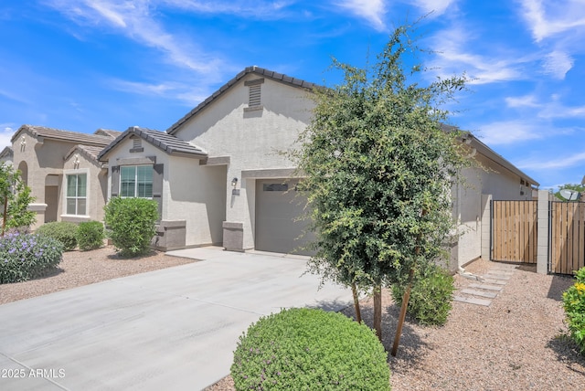 38150 W San Sisto Ave, Maricopa, AZ 85138 - view of front of house featuring concrete driveway, stucco siding, an attached garage, a gate, and a tiled roof