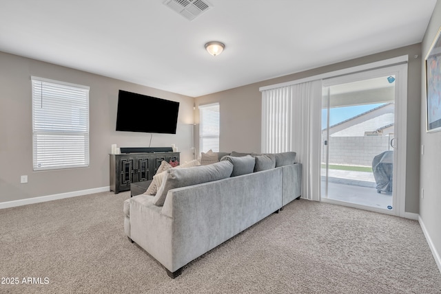 38150 W San Sisto Ave, Maricopa, AZ 85138 - living area featuring light carpet, baseboards, and healthy amount of natural light