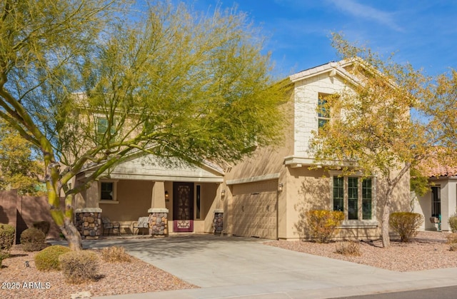 view of front of house featuring a garage, driveway, and stucco siding