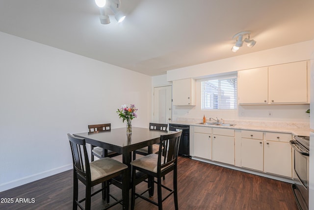 kitchen featuring black dishwasher, baseboards, electric range oven, dark wood-type flooring, and light countertops