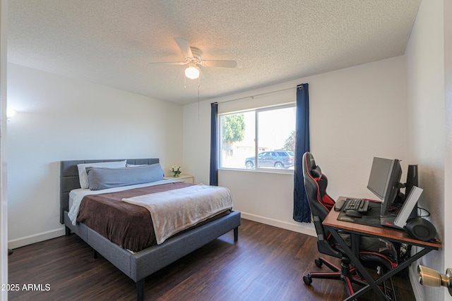 bedroom with a textured ceiling, baseboards, and dark wood-style flooring