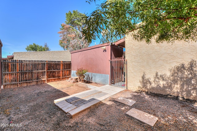 view of yard featuring fence and a gate