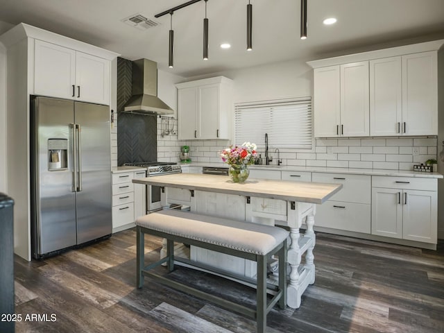 5110 E Peak View Rd, Cave Creek, AZ 85331 - kitchen featuring dark wood-style flooring, visible vents, wall chimney exhaust hood, stainless steel appliances, and a sink
