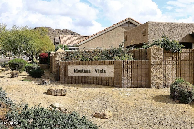 community sign with a mountain view