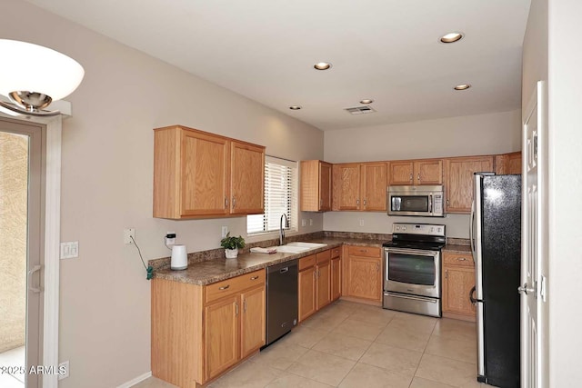 kitchen with sink, light tile patterned floors, and stainless steel appliances