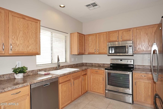 kitchen featuring sink, light tile patterned floors, and appliances with stainless steel finishes