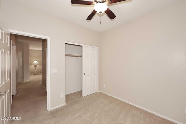 unfurnished bedroom with ceiling fan, a closet, and light carpet