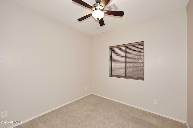 carpeted spare room featuring ceiling fan