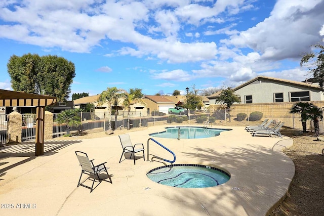 view of pool with a hot tub and a patio