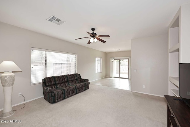 carpeted living room with ceiling fan