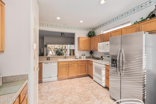 kitchen with a sink, recessed lighting, white appliances, light countertops, and light tile patterned floors