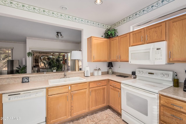 kitchen featuring a sink, white appliances, plenty of natural light, and light countertops