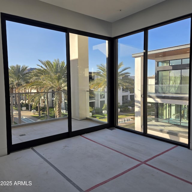 doorway to outside with a wealth of natural light and concrete flooring