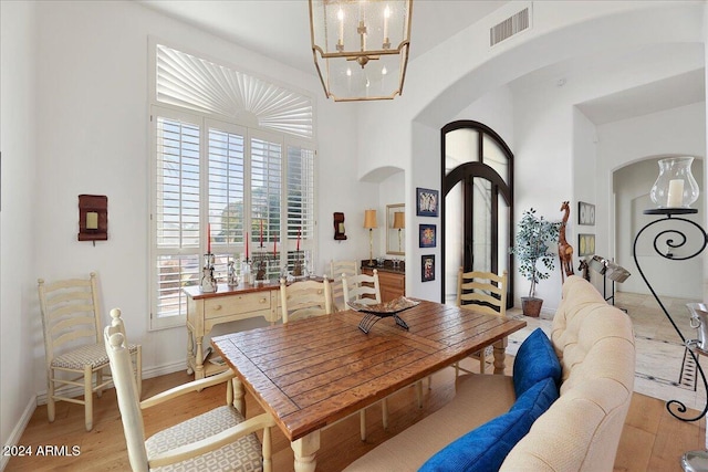 dining space with a chandelier and light wood-type flooring