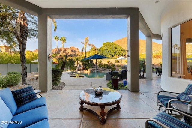 view of patio / terrace featuring a fenced in pool and a mountain view