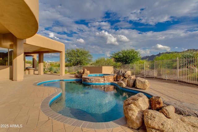 view of pool featuring a patio area, a fenced backyard, and a pool with connected hot tub