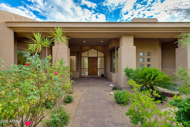 property entrance with stucco siding