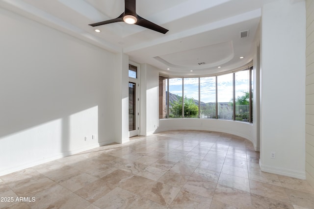 unfurnished room with recessed lighting, a ceiling fan, baseboards, visible vents, and a tray ceiling