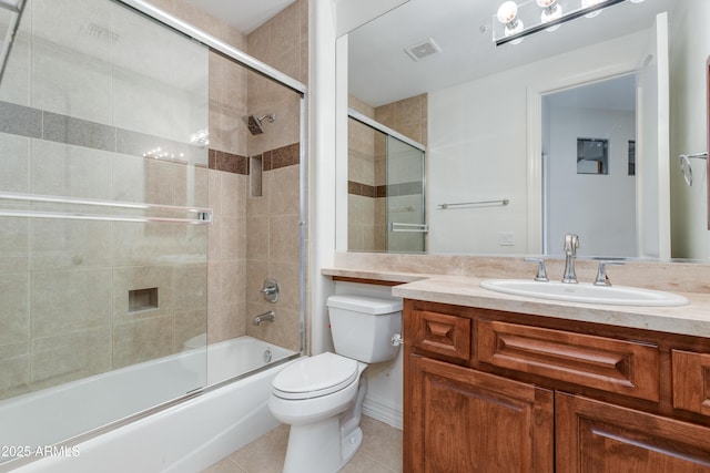 full bath with visible vents, bath / shower combo with glass door, toilet, tile patterned flooring, and vanity