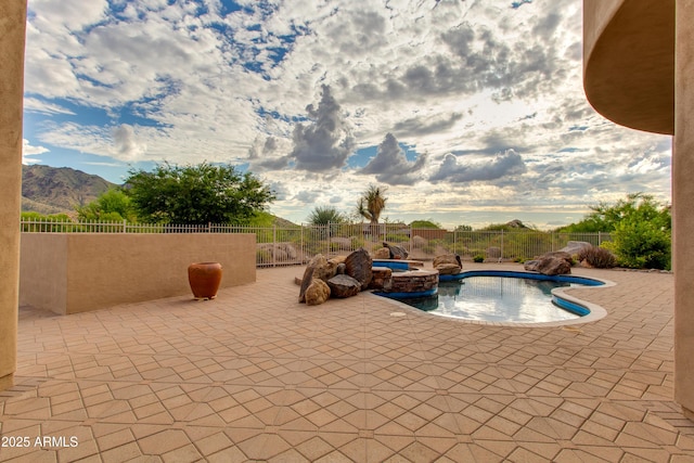 view of swimming pool with fence, a mountain view, a fenced in pool, and a patio