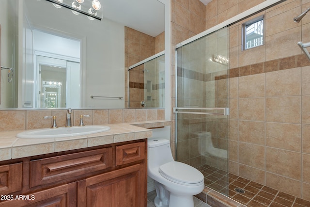 full bathroom featuring vanity, a shower stall, toilet, and decorative backsplash