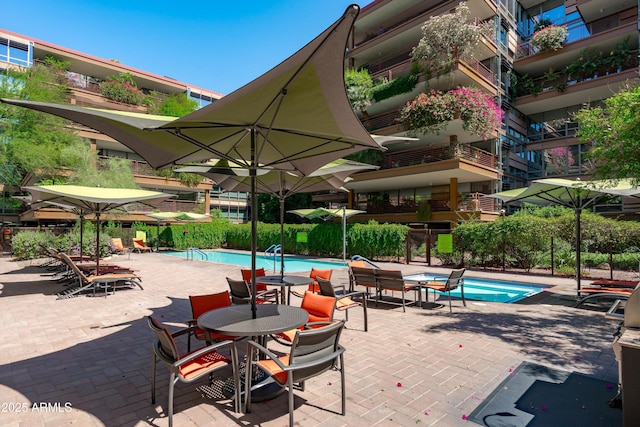 7131 E Rancho Vista Dr Unit 1008, Scottsdale, AZ 85251 - view of community featuring a swimming pool and a patio area