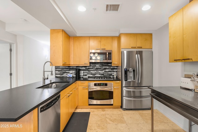 7131 E Rancho Vista Dr Unit 1008, Scottsdale, AZ 85251 - kitchen with appliances with stainless steel finishes, a sink, tasteful backsplash, dark countertops, and a peninsula