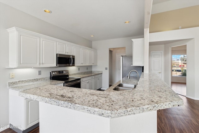 kitchen featuring a kitchen island, appliances with stainless steel finishes, sink, white cabinets, and dark wood-type flooring