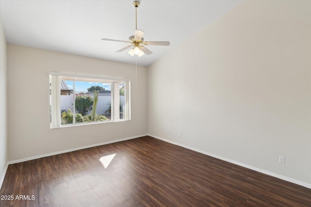 spare room with dark hardwood / wood-style floors and ceiling fan