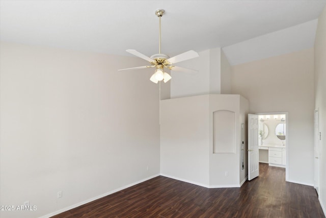 spare room with high vaulted ceiling, dark hardwood / wood-style floors, and ceiling fan