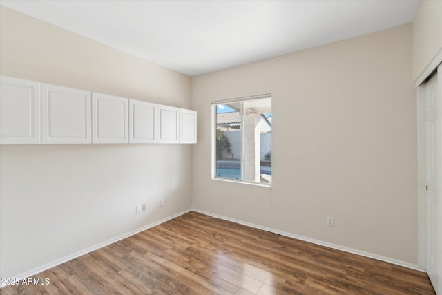 spare room featuring hardwood / wood-style flooring