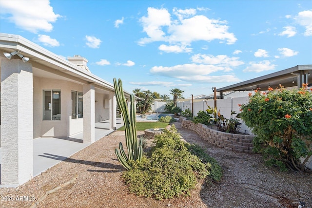 view of yard featuring a patio and an outdoor fire pit