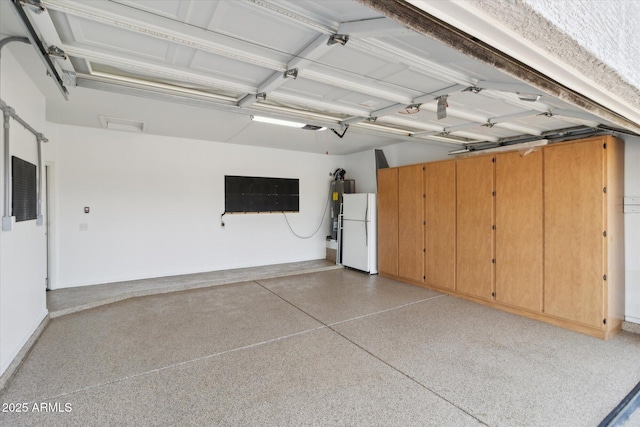 garage featuring a garage door opener and white refrigerator