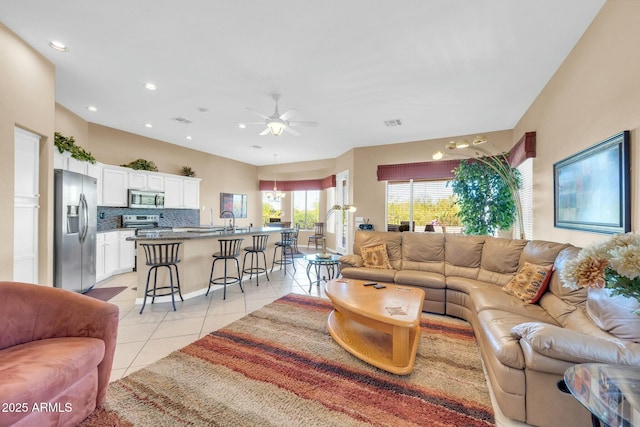 4240 E Strawberry Dr, Gilbert, AZ 85298 - living room with visible vents, light tile patterned floors, a ceiling fan, and recessed lighting