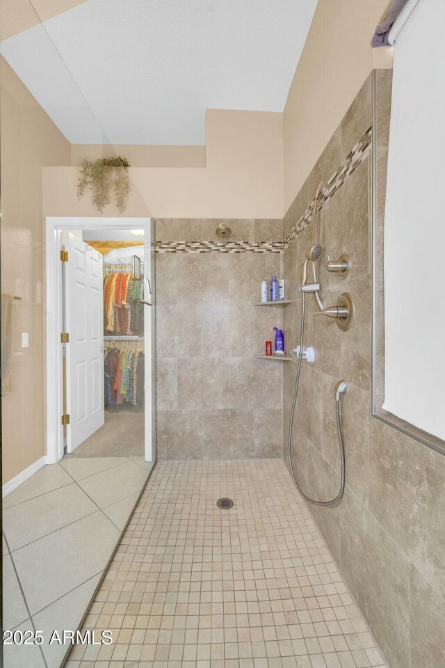 4240 E Strawberry Dr, Gilbert, AZ 85298 - bathroom featuring tile patterned floors, tiled shower, and vaulted ceiling