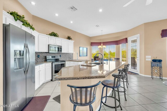 4240 E Strawberry Dr, Gilbert, AZ 85298 - kitchen featuring a sink, tasteful backsplash, light tile patterned flooring, and stainless steel appliances