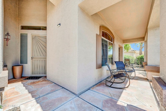 4240 E Strawberry Dr, Gilbert, AZ 85298 - view of exterior entry with a porch and stucco siding