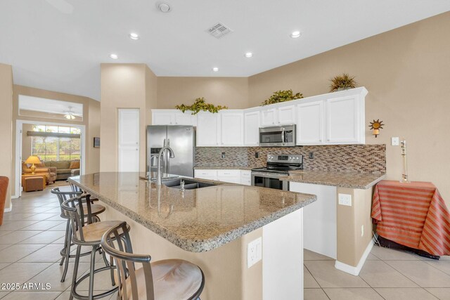 4240 E Strawberry Dr, Gilbert, AZ 85298 - kitchen with tasteful backsplash, visible vents, a sink, stainless steel appliances, and light tile patterned flooring