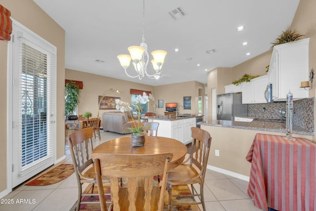 4240 E Strawberry Dr, Gilbert, AZ 85298 - dining area with light tile patterned floors, a notable chandelier, visible vents, and plenty of natural light