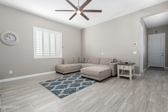 living room with ceiling fan and light hardwood / wood-style flooring