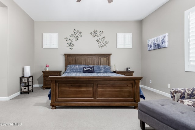 bedroom with light carpet and ceiling fan