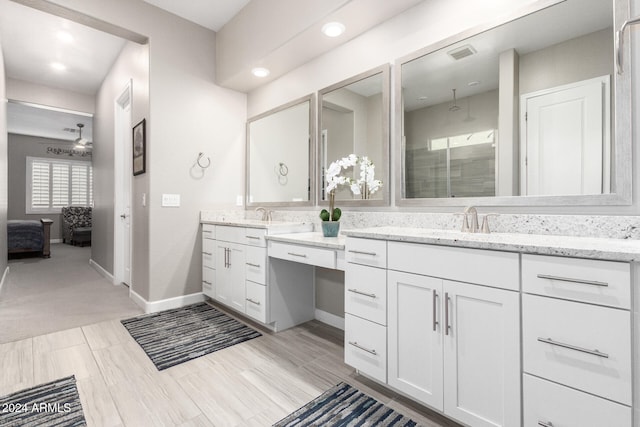 bathroom featuring vanity, ceiling fan, and a shower