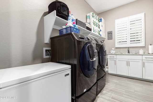 laundry area featuring sink and washer and dryer