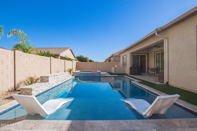 view of pool with a patio area and an in ground hot tub