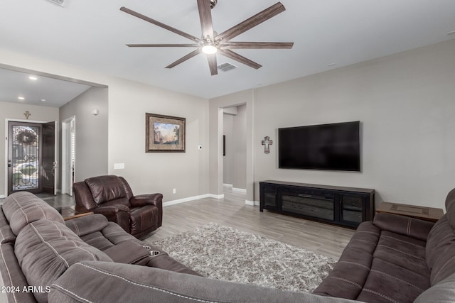 living room featuring light hardwood / wood-style floors and ceiling fan