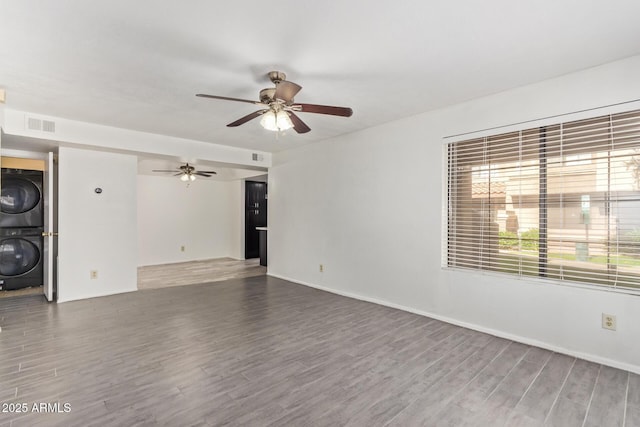 1905 E University Dr Unit 139, Tempe, AZ 85288 - unfurnished living room featuring stacked washer / dryer, wood finished floors, and ceiling fan