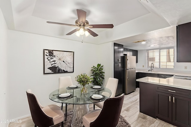 1905 E University Dr Unit 139, Tempe, AZ 85288 - dining room featuring a ceiling fan, light wood finished floors, and a raised ceiling