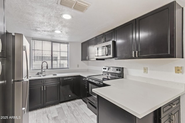 1905 E University Dr Unit 139, Tempe, AZ 85288 - kitchen featuring black appliances, a textured ceiling, light countertops, and recessed lighting