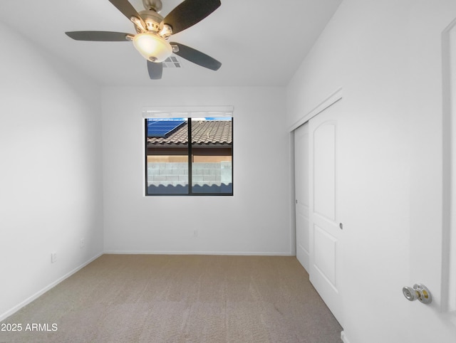 unfurnished bedroom featuring visible vents, baseboards, a closet, and carpet floors