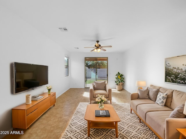 living room featuring light tile patterned floors, a ceiling fan, and visible vents